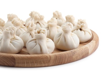 Photo of Wooden board with uncooked khinkali (dumplings) isolated on white. Georgian cuisine