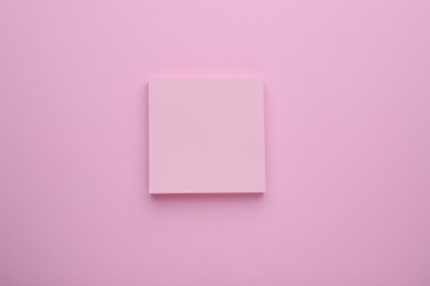 Photo of Paper note on pale pink background, top view