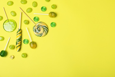 Photo of Flat lay composition with different candies and space for text on color background