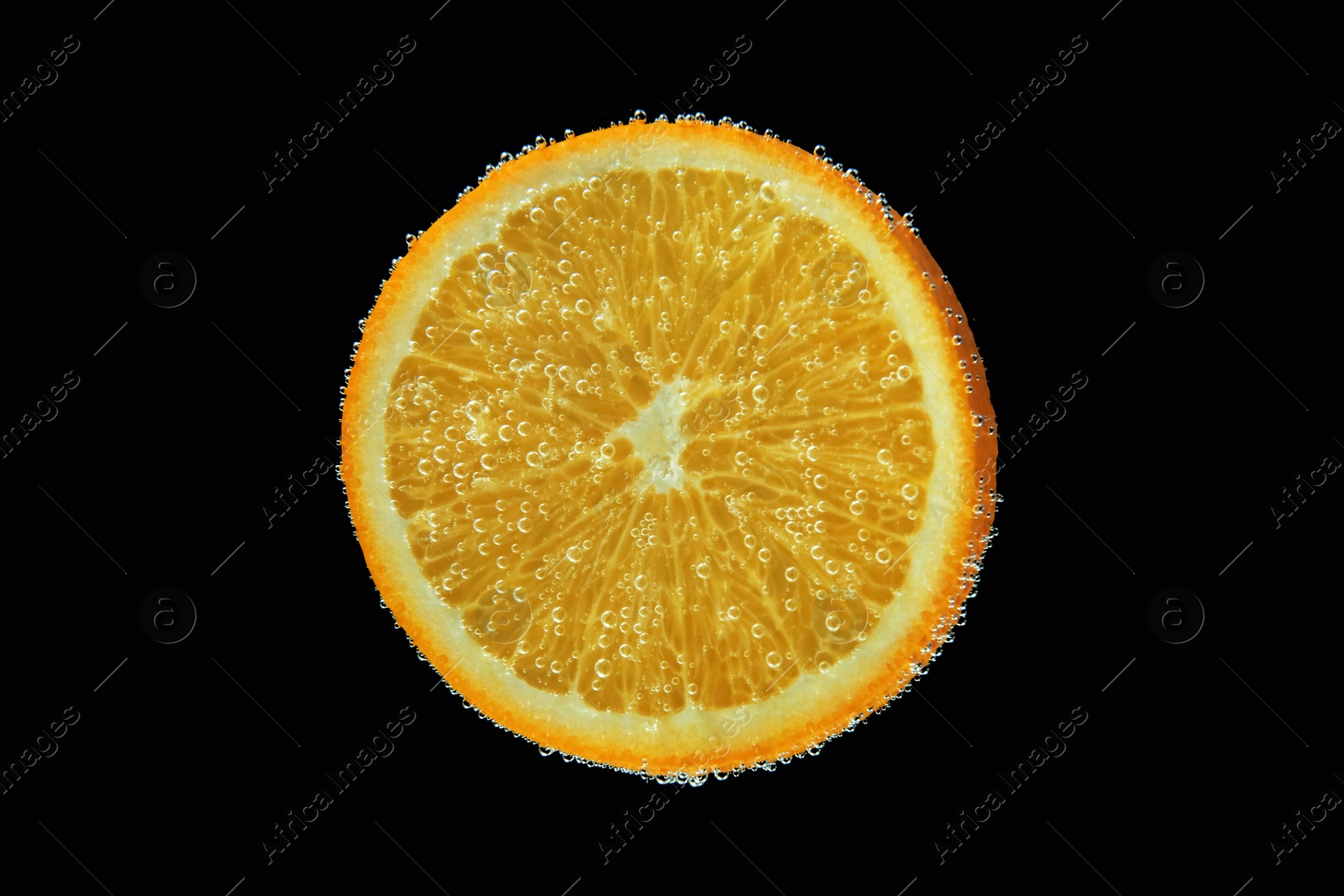 Photo of Slice of orange in sparkling water on black background. Citrus soda