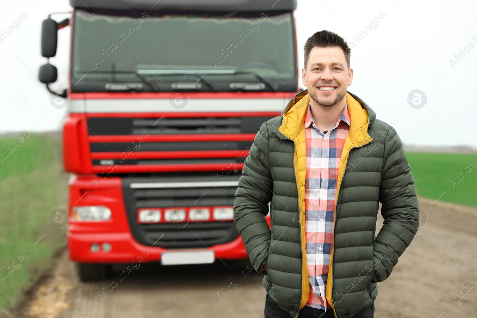 Photo of Portrait of driver at modern truck outdoors