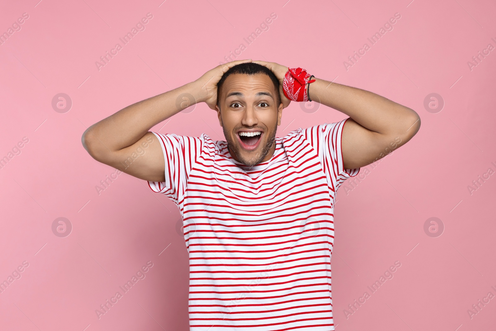 Photo of Portrait of emotional African American man on pink background