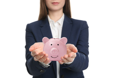 Young woman holding piggy bank on white background, closeup 