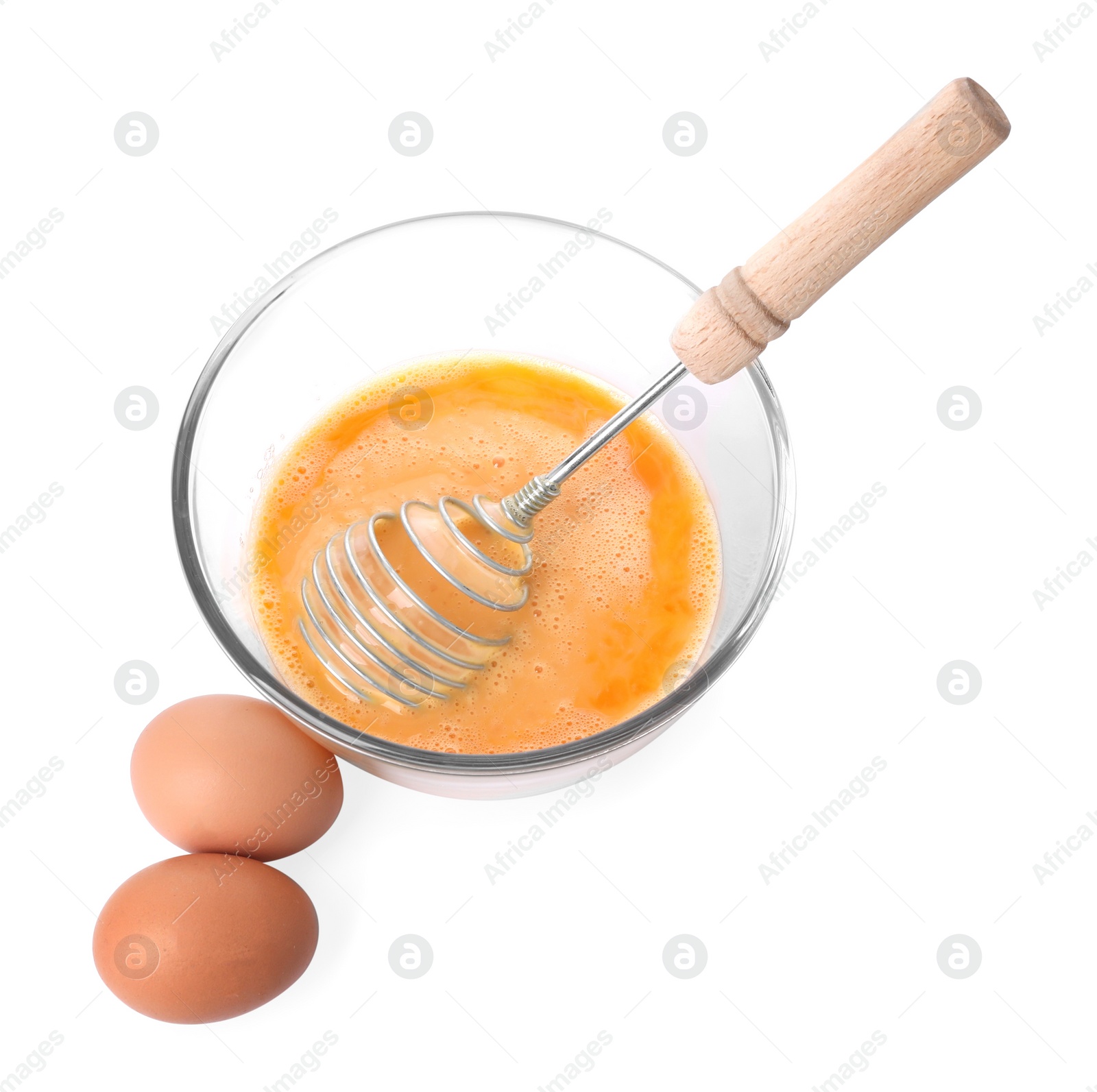 Photo of Beaten eggs and whisk in glass bowl isolated on white