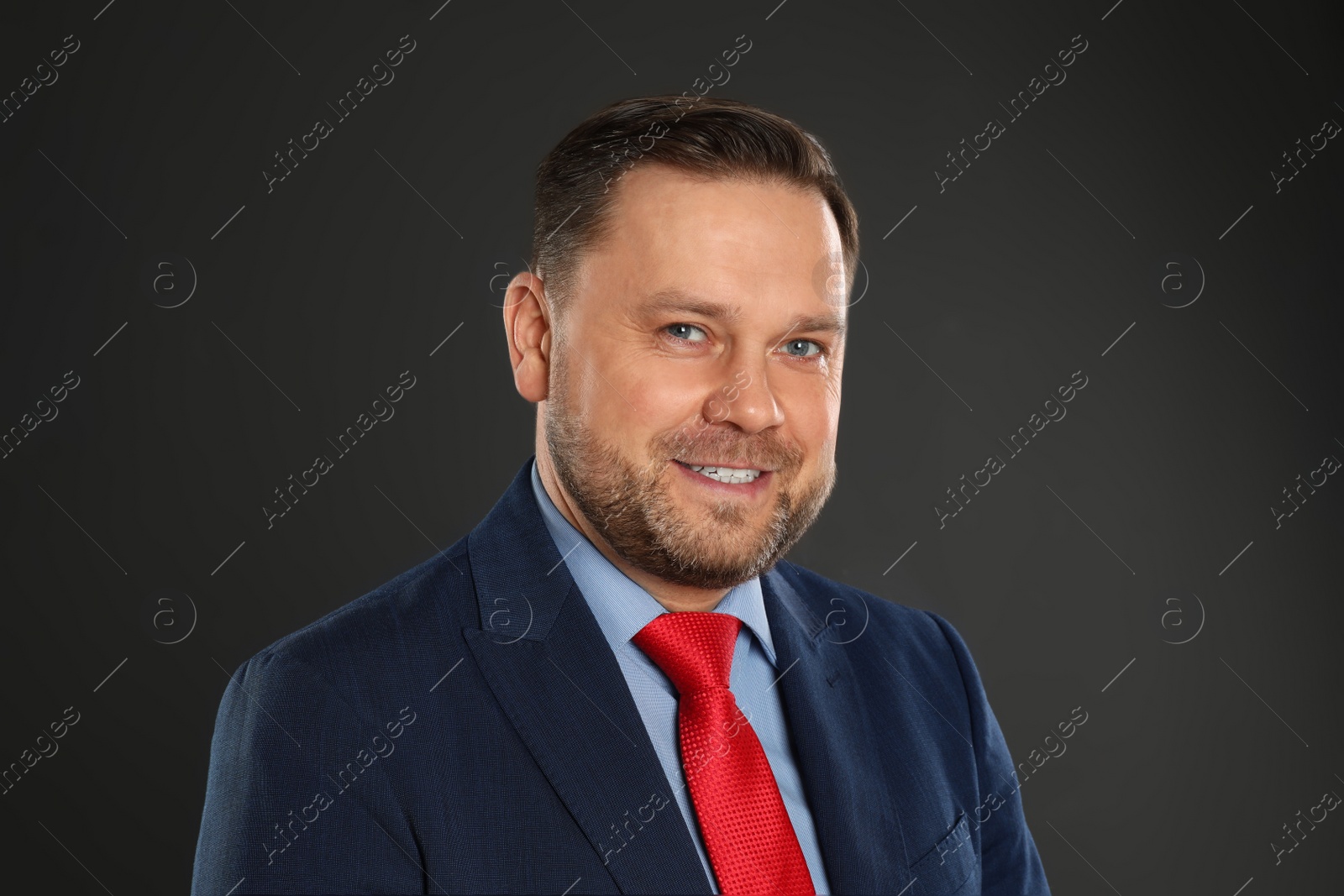 Photo of Portrait of happy mature man on black background