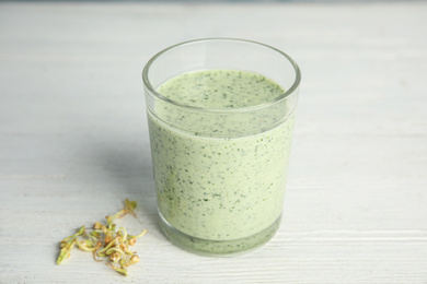 Photo of Green buckwheat smoothie on white wooden table