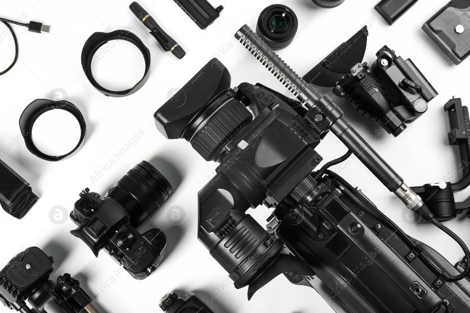 Photo of Flat lay composition with video camera and other equipment on white background