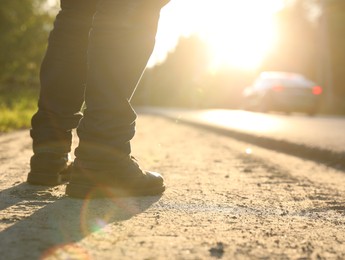 Photo of Man standing near road on sunny day, closeup. Space for text