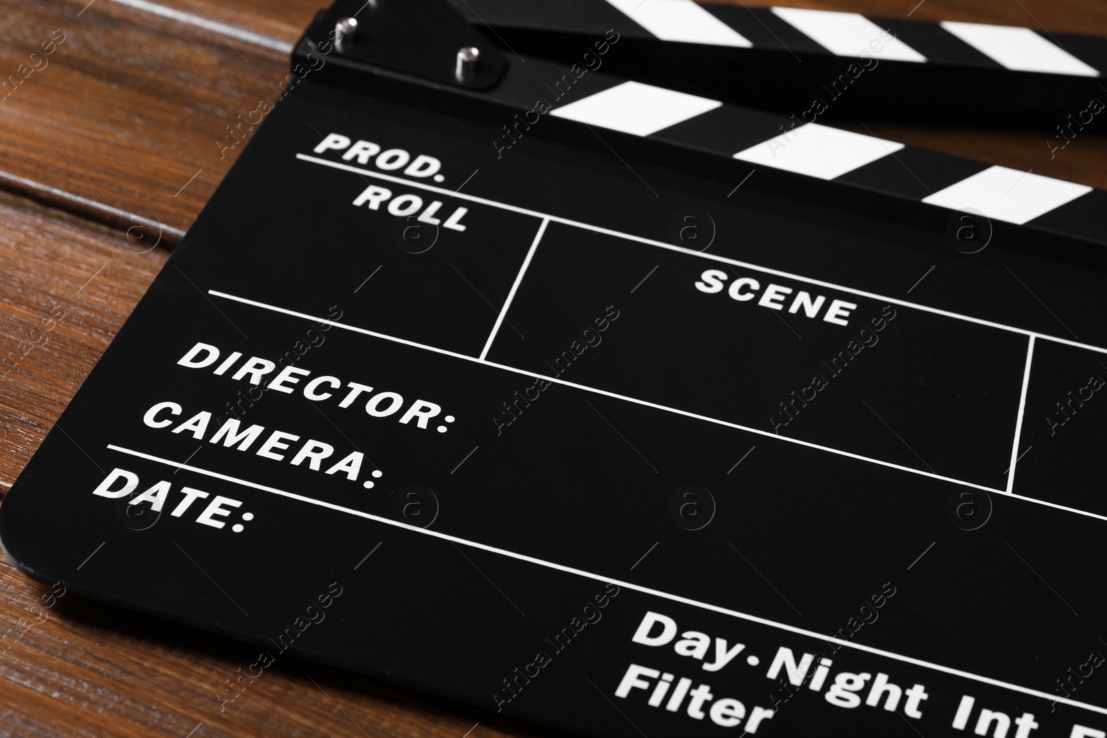 Photo of One clapperboard on wooden table, closeup view