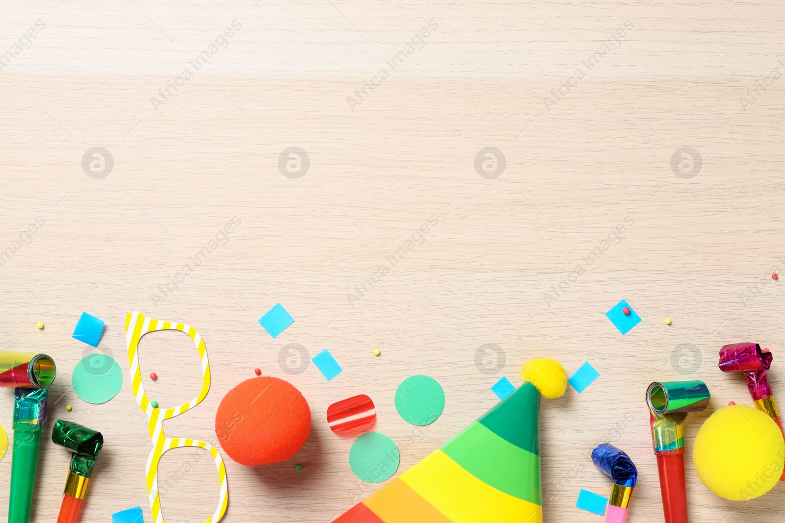 Photo of Flat lay composition with party items on wooden background. Space for text