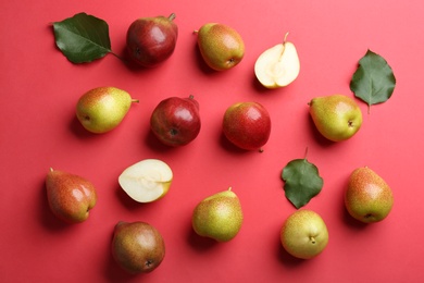 Ripe juicy pears on red background, flat lay