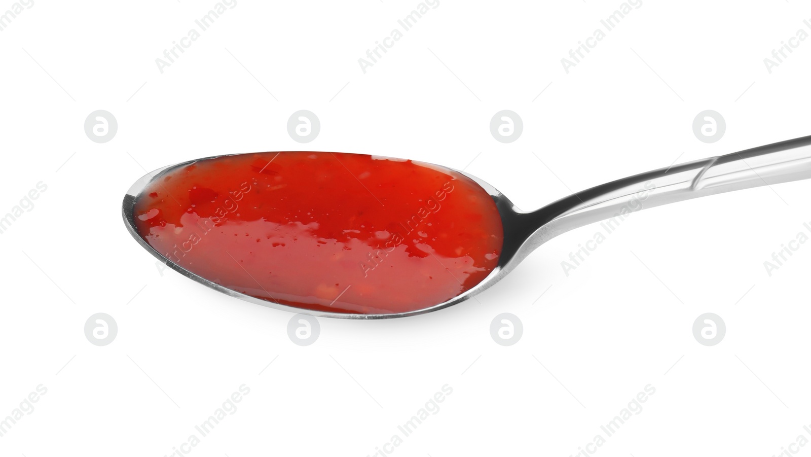 Photo of Spicy chili sauce in spoon isolated on white