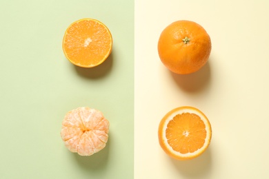 Flat lay composition with ripe oranges on color background