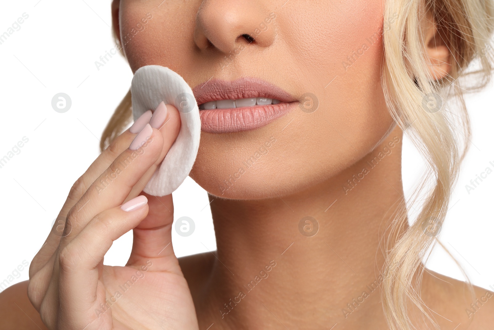 Photo of Woman removing makeup with cotton pad on white background, closeup