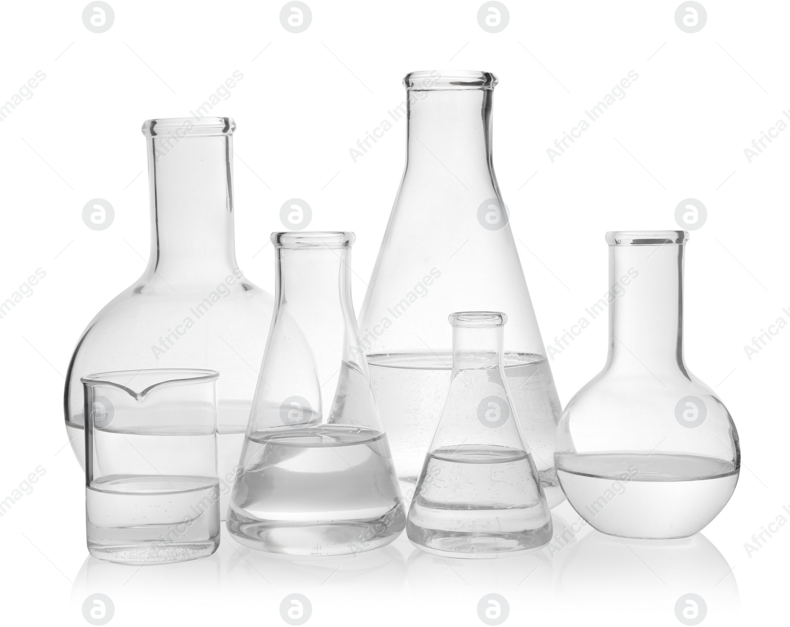 Photo of Laboratory glassware with transparent liquid on white background