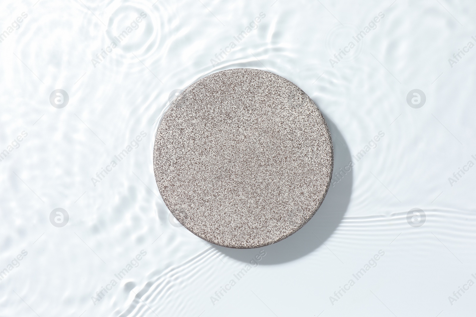 Photo of Presentation for product. Stone podium in water on white background, top view