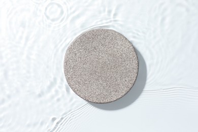 Photo of Presentation for product. Stone podium in water on white background, top view