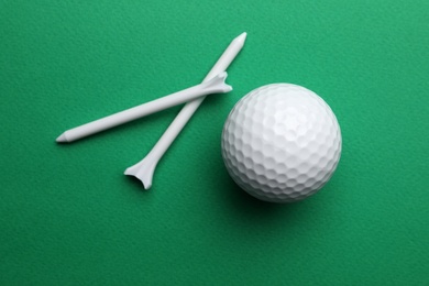 Photo of Golf ball and tees on color background, flat lay. Sport equipment