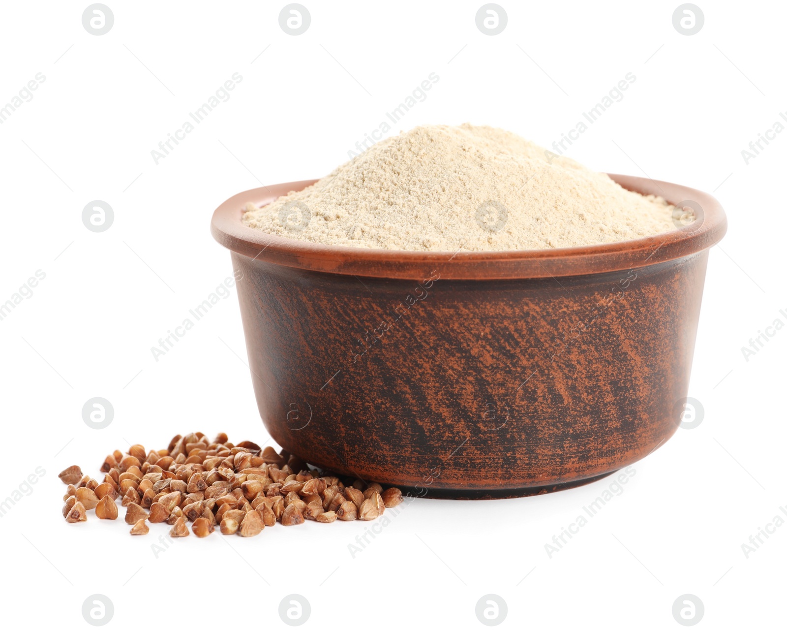 Photo of Bowl of buckwheat flour on white background