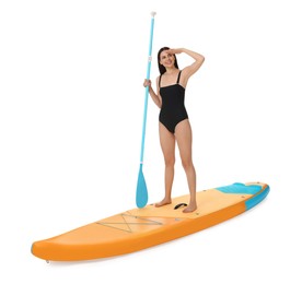 Photo of Happy woman with paddle on orange SUP board against white background