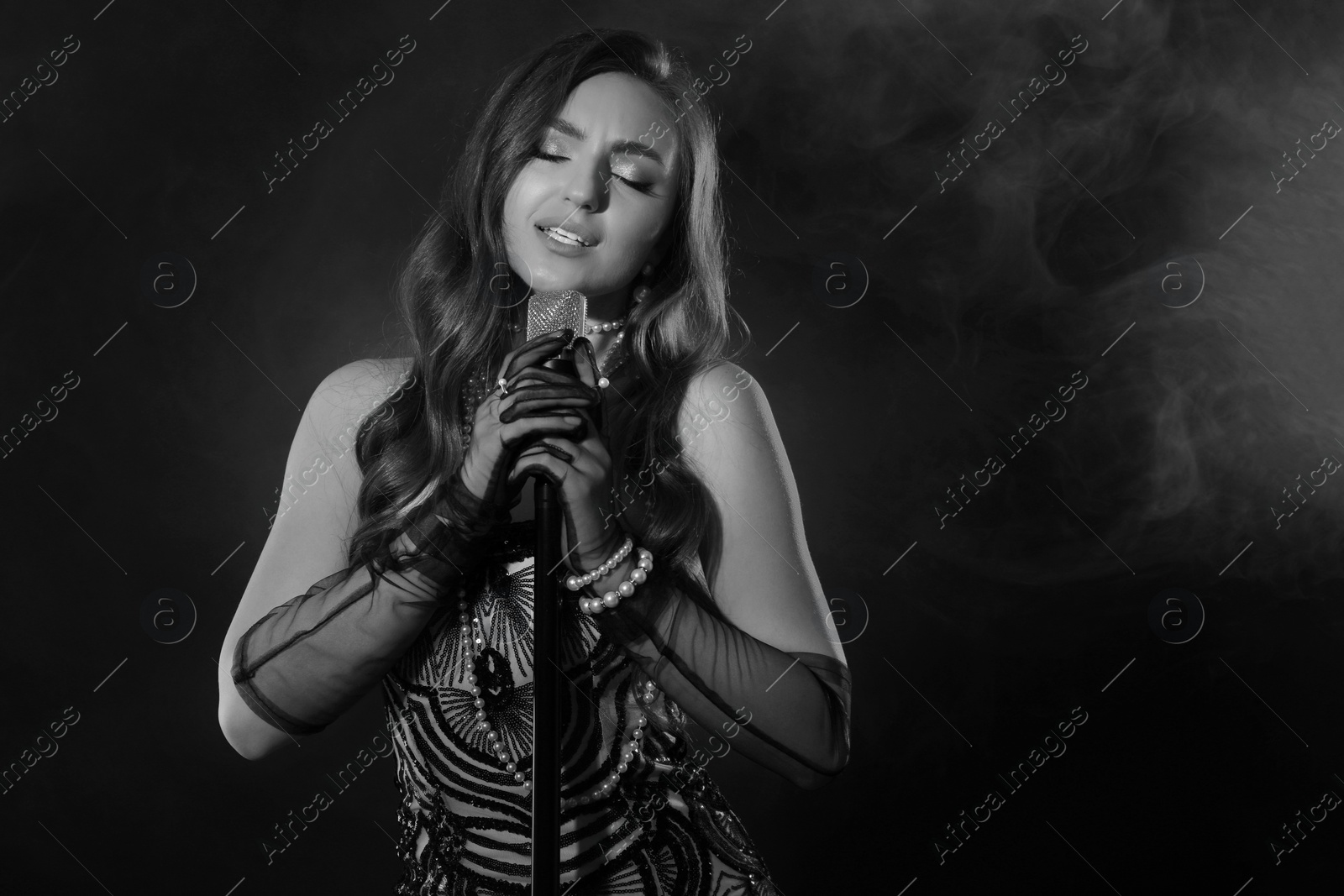 Image of Beautiful singer with microphone, black and white effect