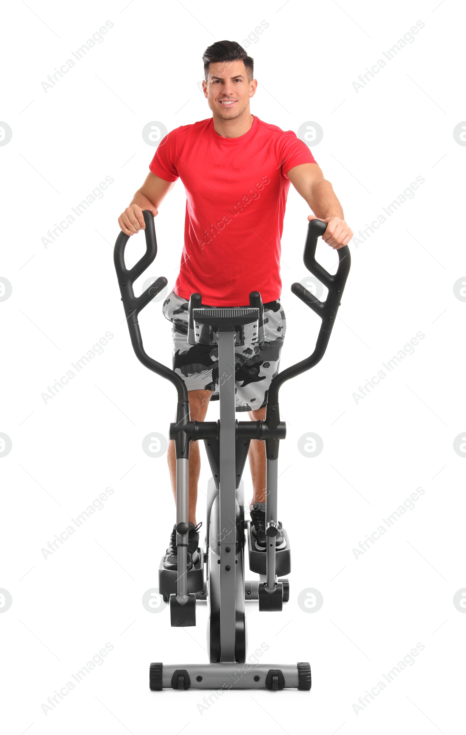 Photo of Man using modern elliptical machine on white background