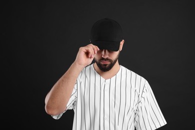 Photo of Man in stylish baseball cap on black background