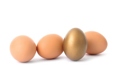 Photo of Golden egg among others on white background