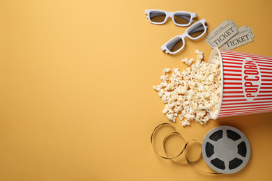 Photo of Flat lay composition with delicious popcorn on yellow background. Space for text