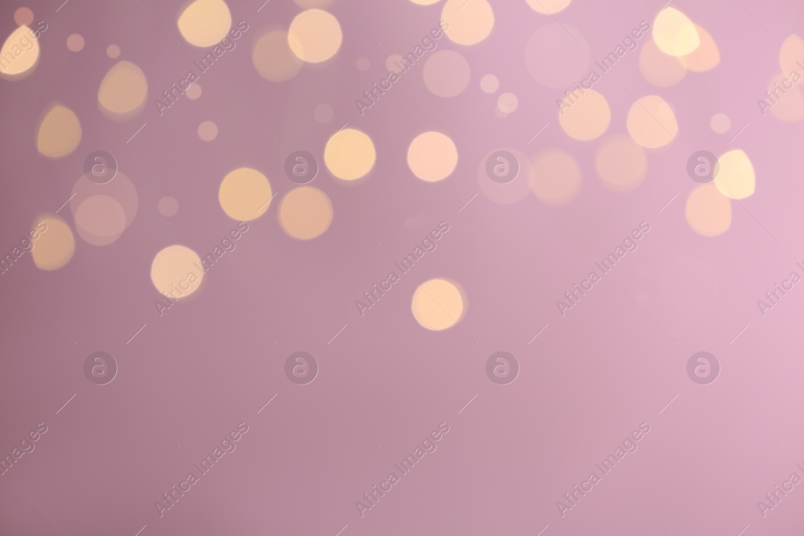 Photo of Blurred view of festive lights on purple background, space for text. Bokeh effect