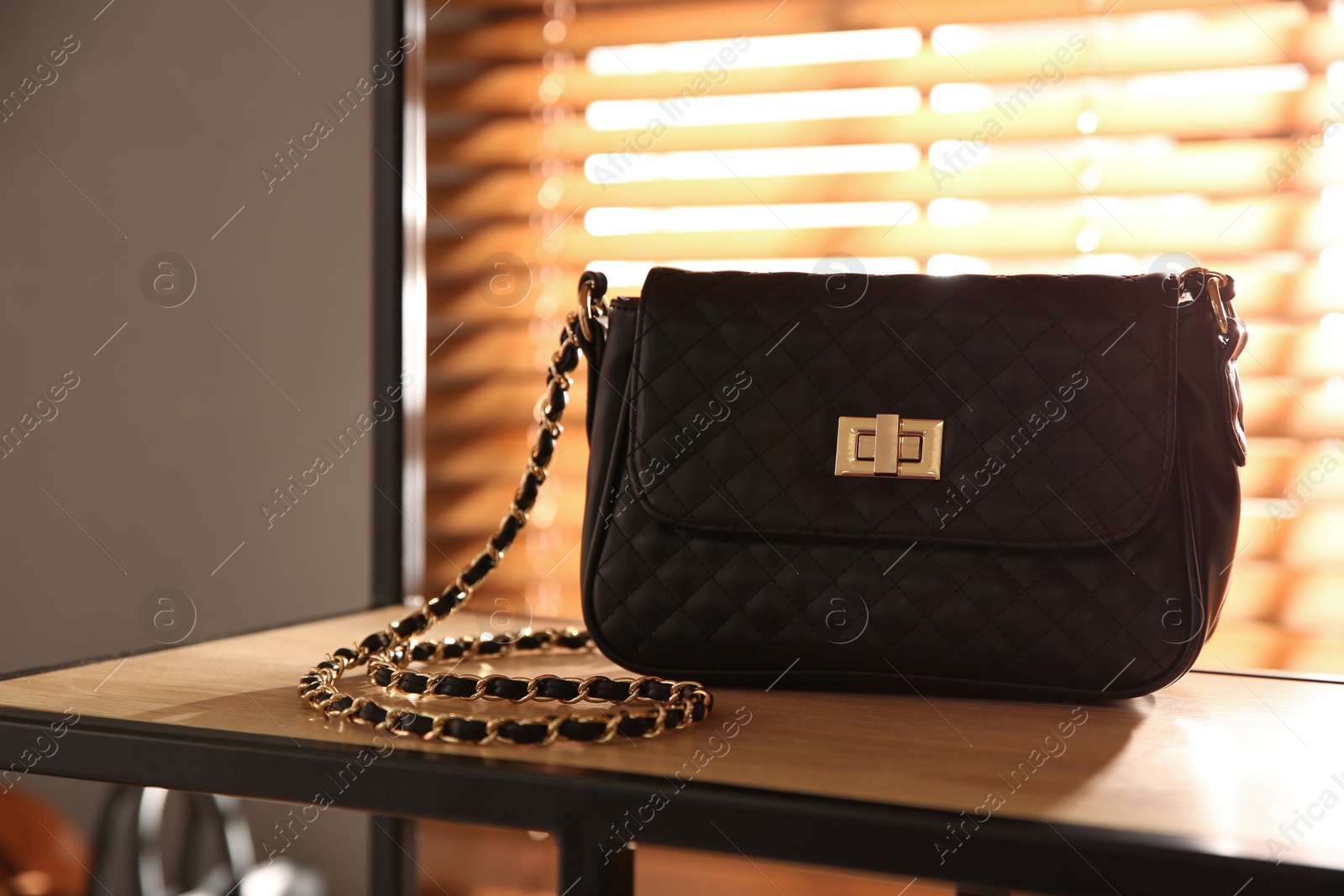 Photo of Stylish woman's bag on shelf in boutique