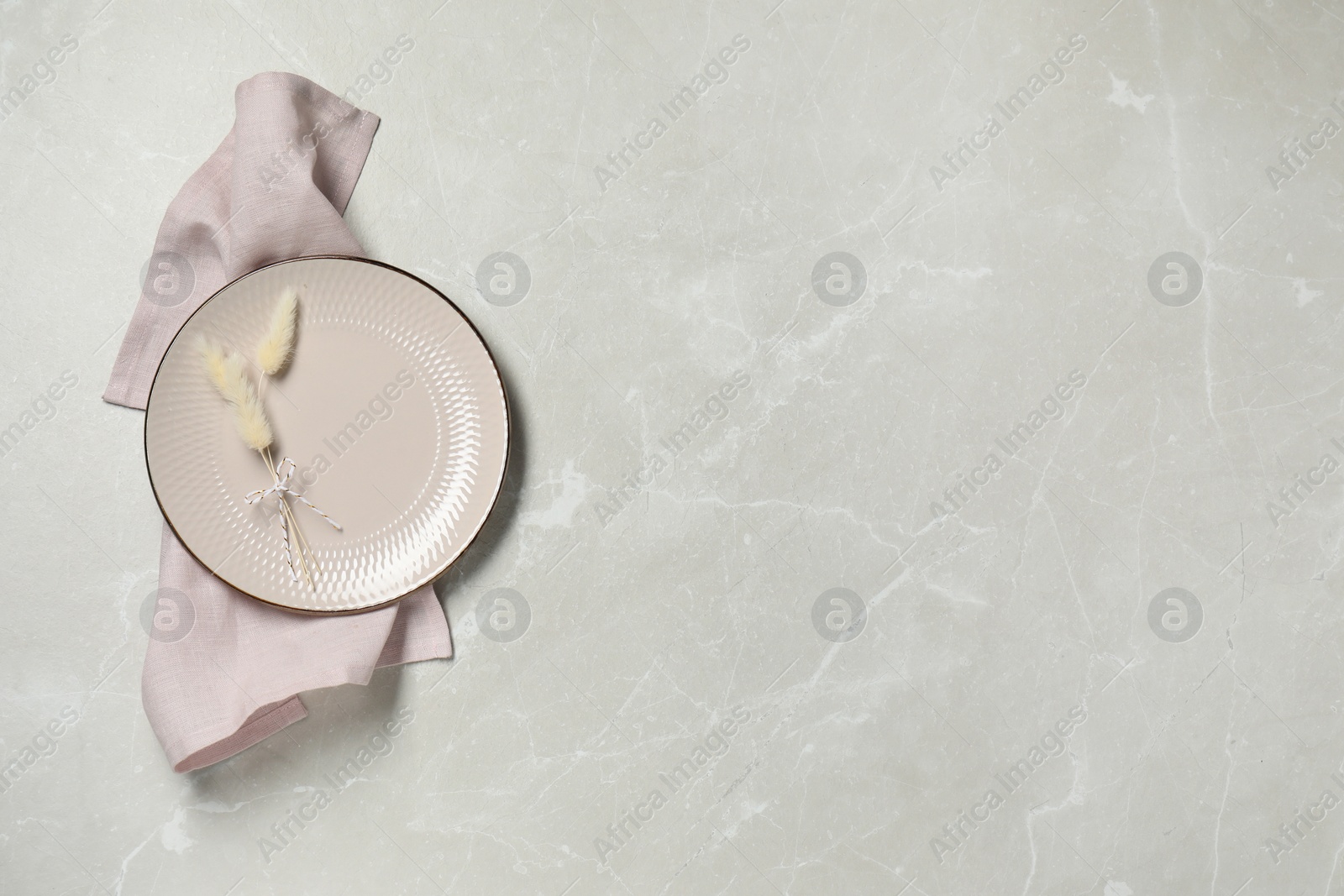 Elegant plate with spikes and napkin on marble table, top view. Space for text Photo of Elegant plate with spikes and napkin on marble table, top view. Space for text