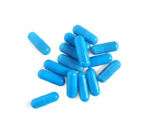 Pile of blue pills on white background, top view