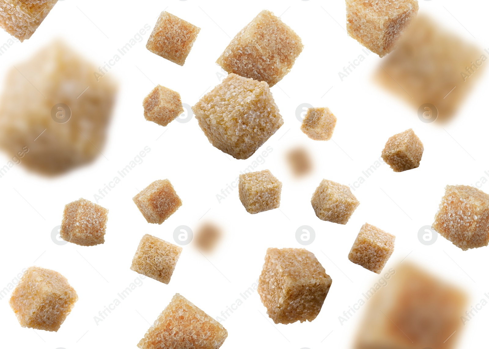 Image of Brown cane sugar cubes falling on white background