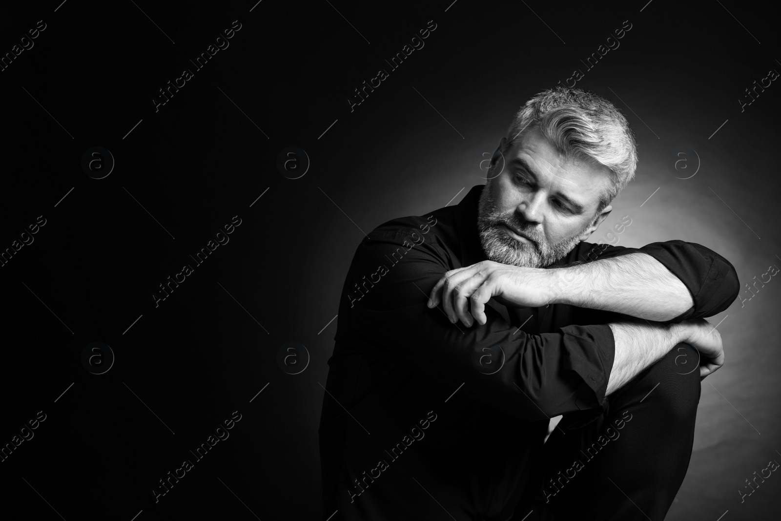 Photo of Portrait of handsome man on dark background, space for text. Black and white effect