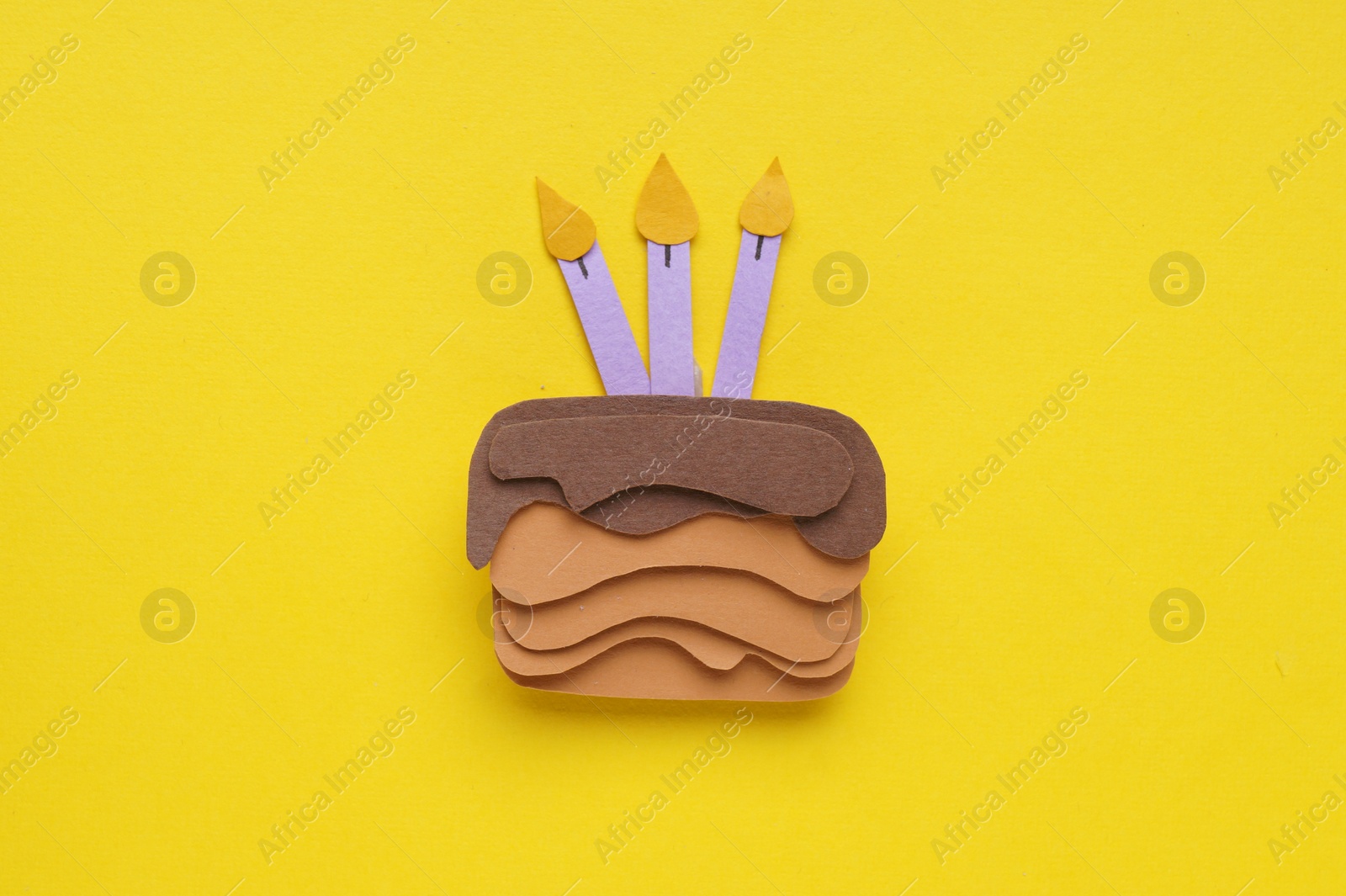Photo of Birthday party. Paper cake on yellow background, top view
