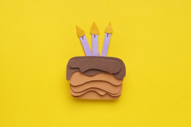 Photo of Birthday party. Paper cake on yellow background, top view