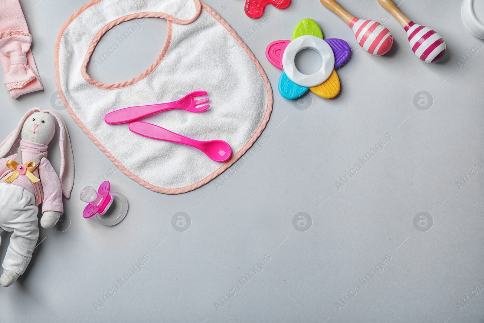 Photo of Flat lay composition with baby accessories and toys on gray background. Space for text