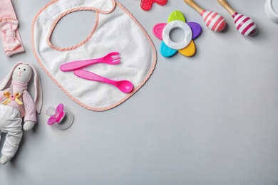 Photo of Flat lay composition with baby accessories and toys on gray background. Space for text