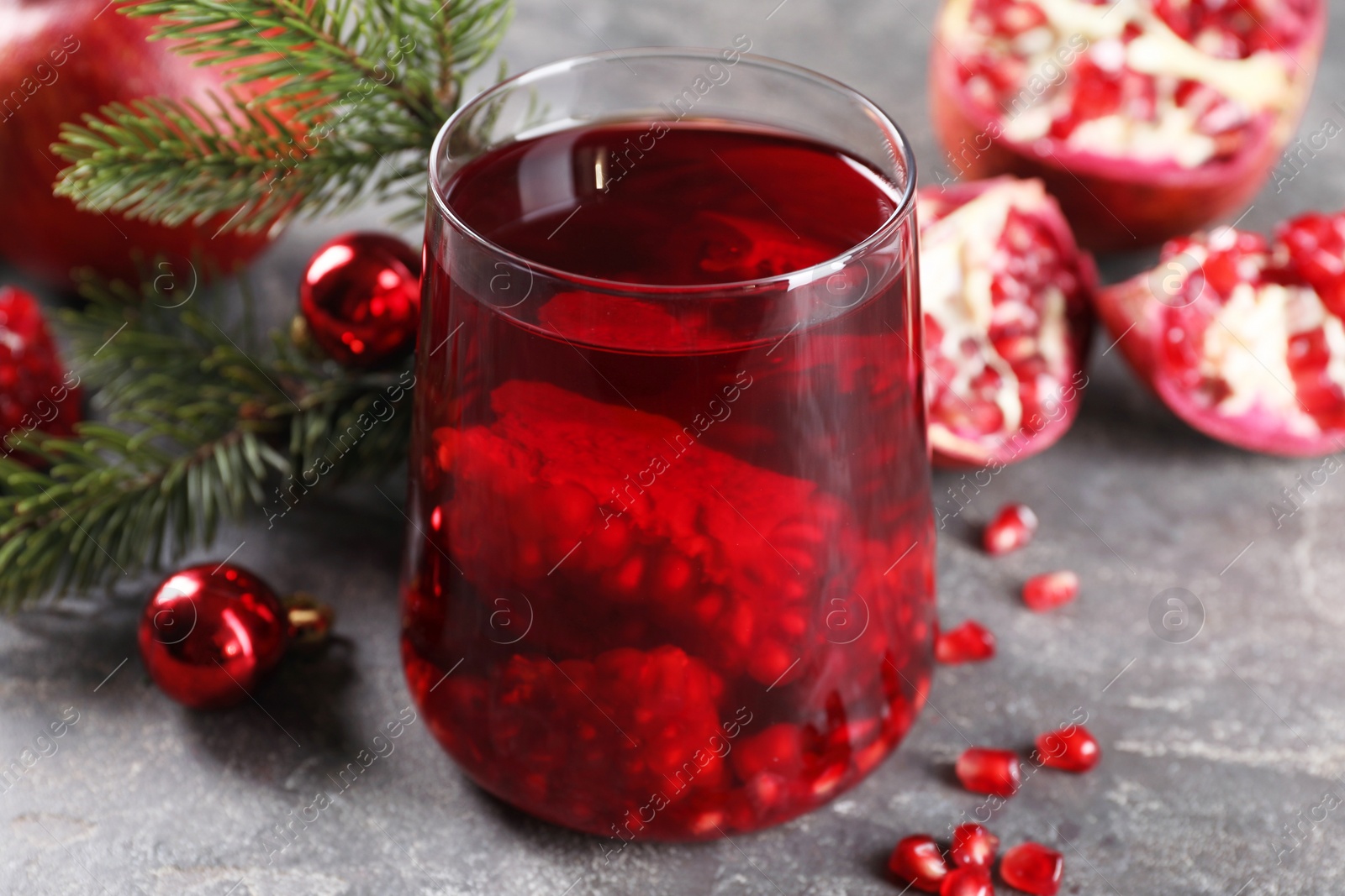 Photo of Aromatic Sangria drink in glass on grey textured table, closeup