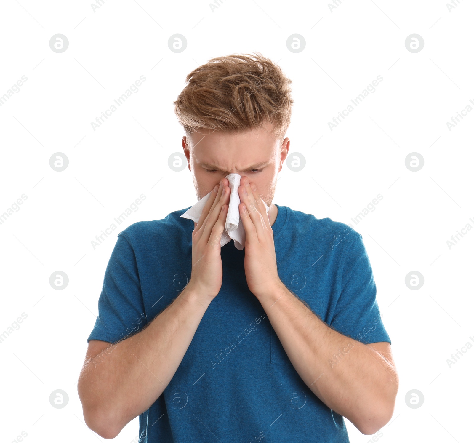 Photo of Handsome young man blowing nose against white background