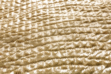 Photo of Golden fabric with shiny paillettes as background