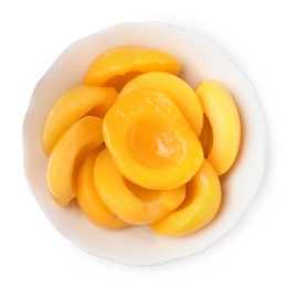 Photo of Halves of canned peaches in bowl isolated on white, top view