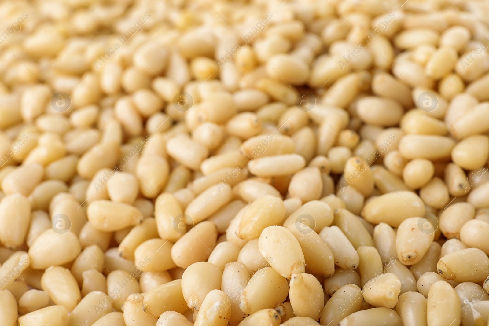 Photo of Pile of pine nuts as background, closeup