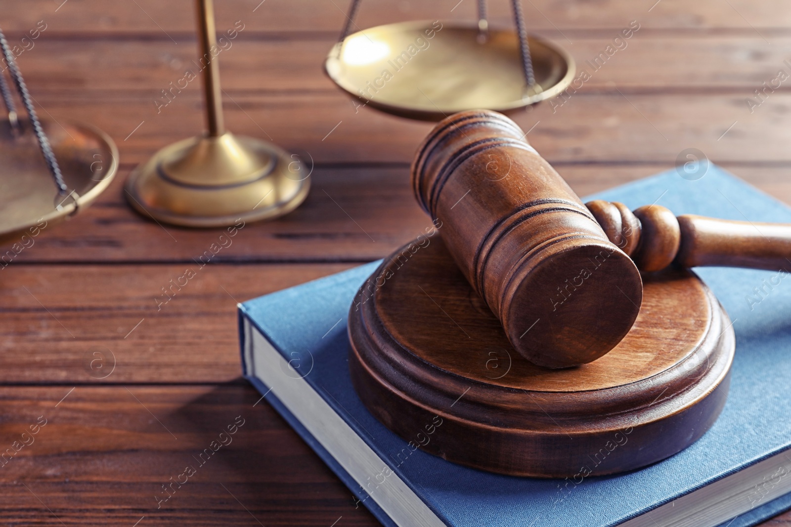 Photo of Judge's gavel, book and scales on table. Law concept