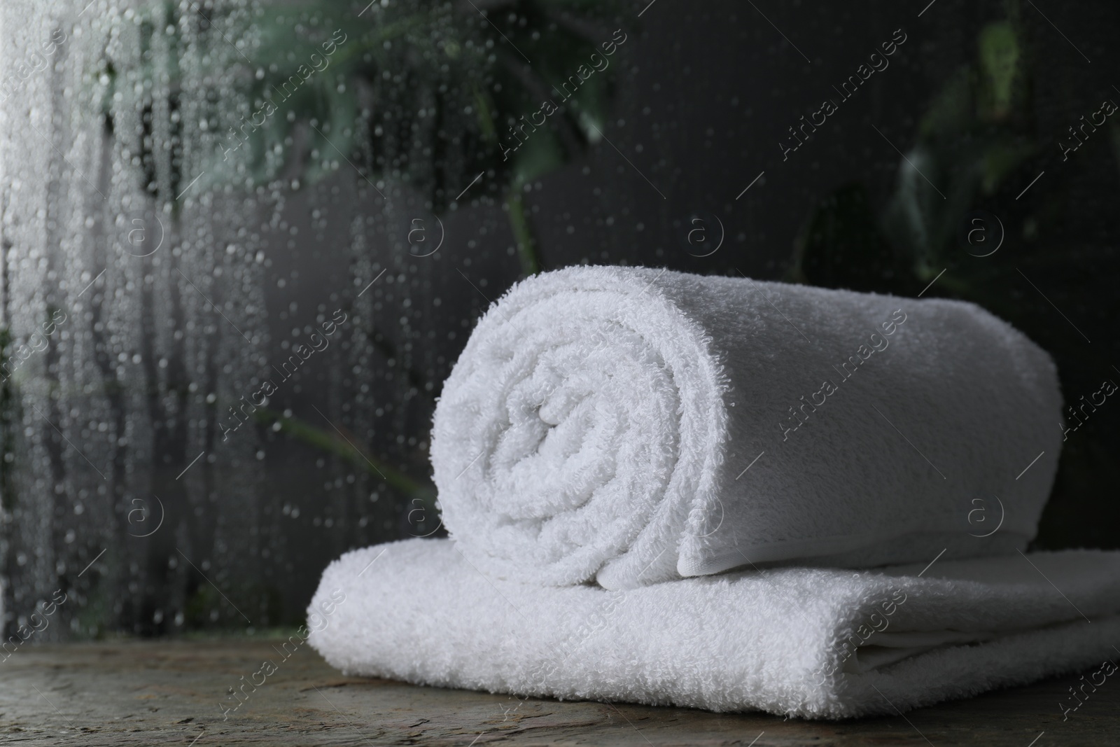 Photo of White terry towels on table in bathroom, space for text