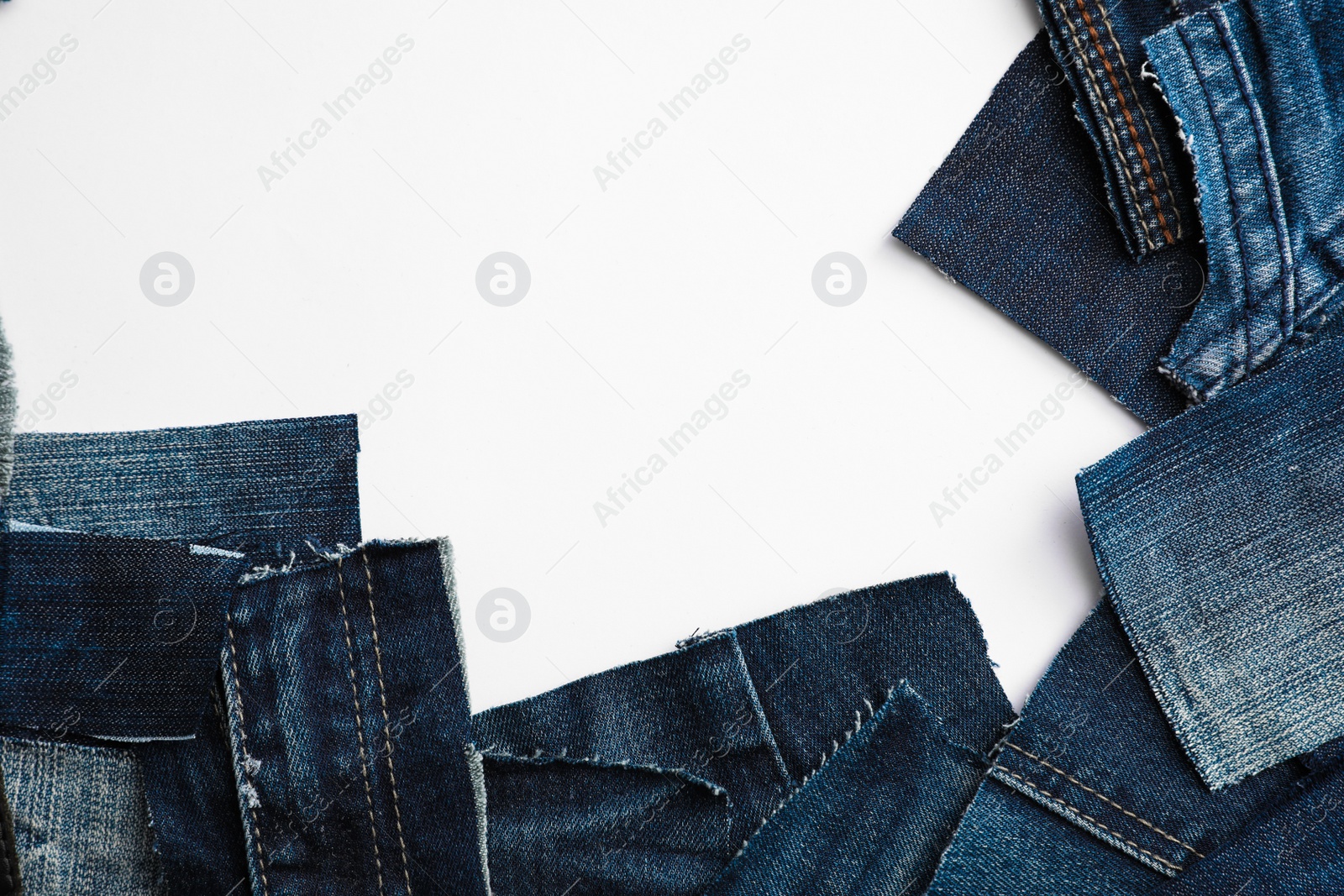 Photo of Many patches of old jeans isolated on white, top view