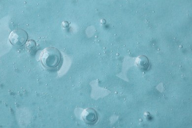 Photo of Cosmetic serum on light blue background, above view