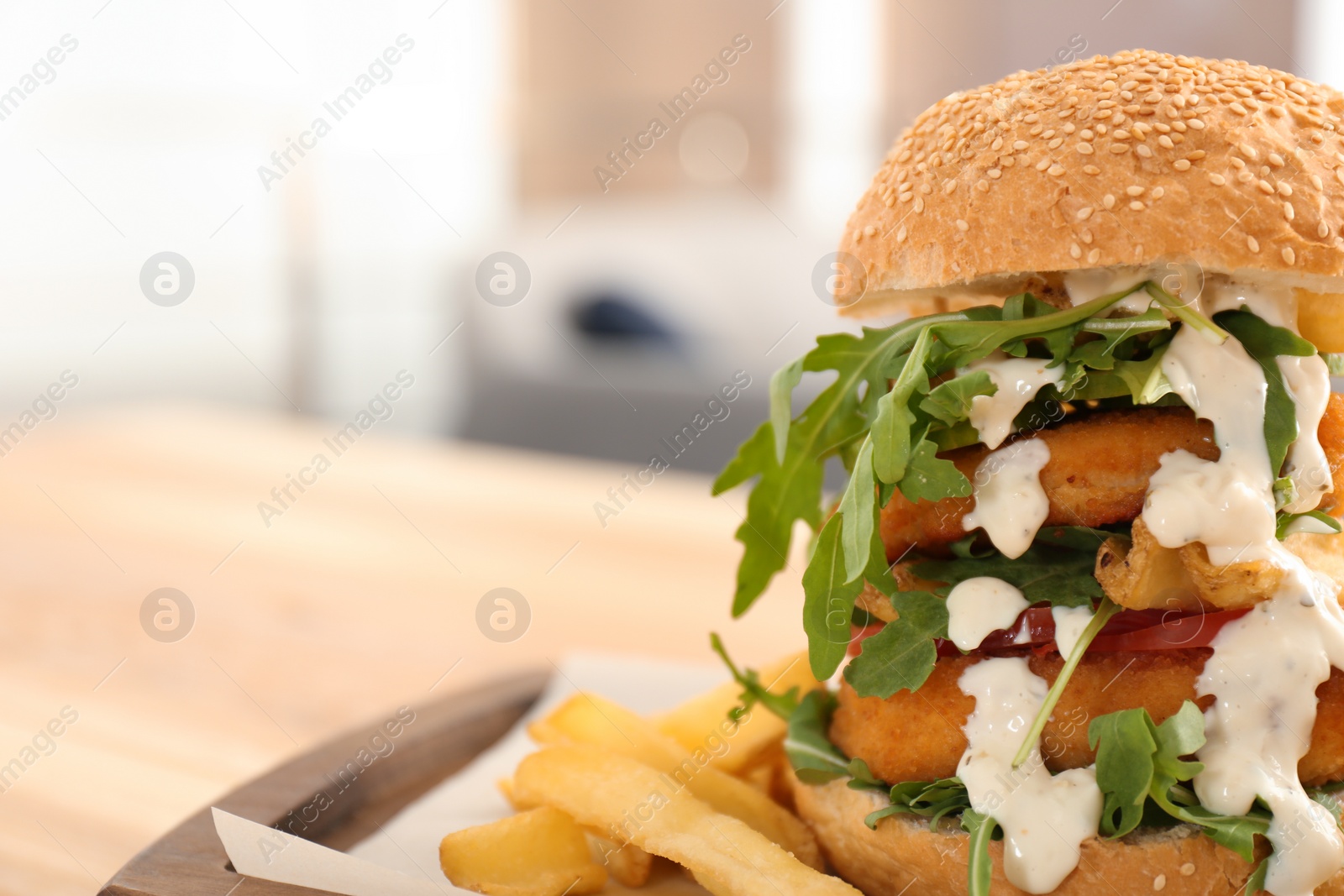 Photo of Huge yummy burger served on table in cafe. Space for text