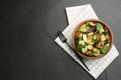 Photo of Delicious fresh celery salad served on black table, flat lay. Space for text